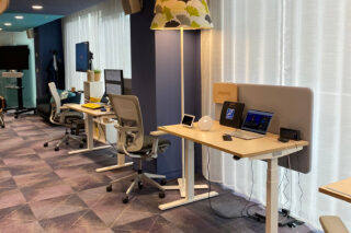 An image from Google's Accessibility Discovery Centre (ADC) in Dublin, showing three desks displaying a variety of Google AI technologies and other innovative products or accessibility solutions.